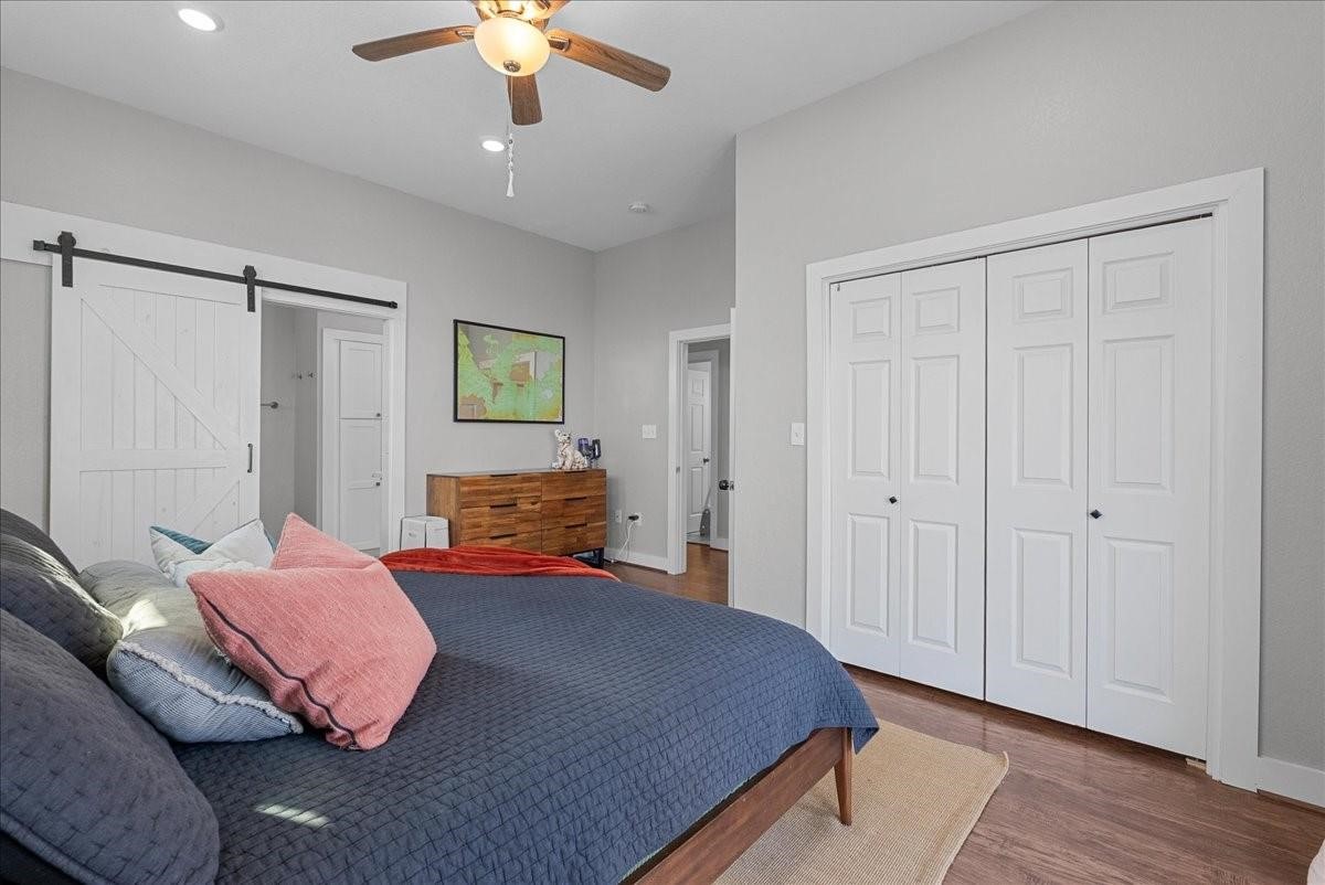 1205 Todville Road Seabrook, TX 77586 - Photo 19 of 37 a bedroom with a bed and a chandelier