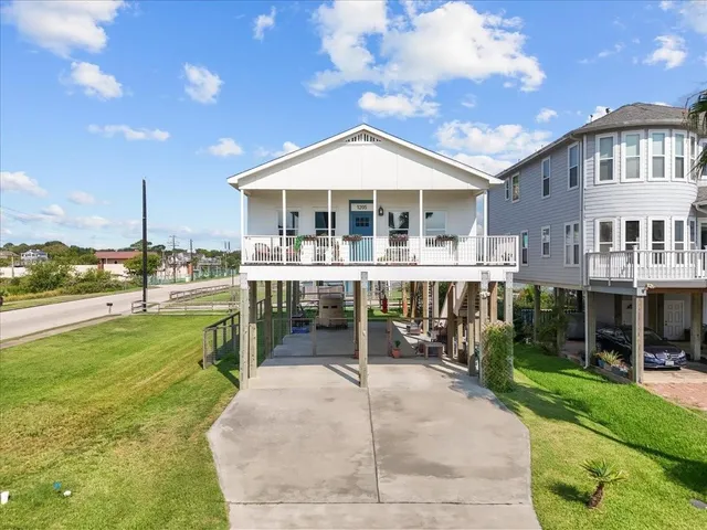 a view of a house with a yard and sitting area
