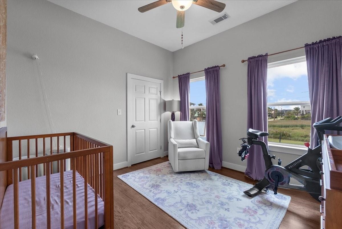 1205 Todville Road Seabrook, TX 77586 - Photo 23 of 37 a living room with furniture floor to ceiling window and a flat screen tv
