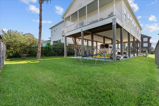 a view of a chair and table in backyard of the house