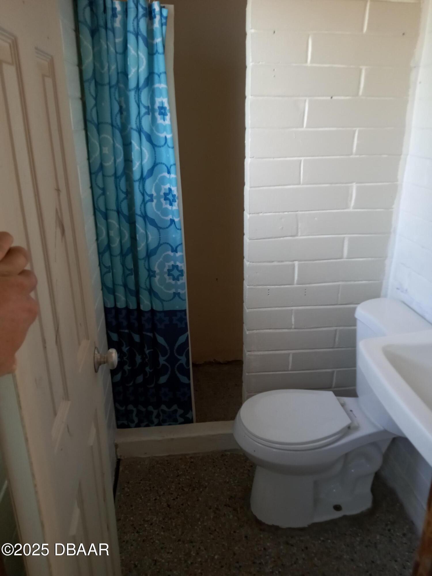 703 South Ridgewood Avenue, Unit 10 Edgewater, FL 32132 - Photo 4 of 5 a bathroom with a toilet and a shower
