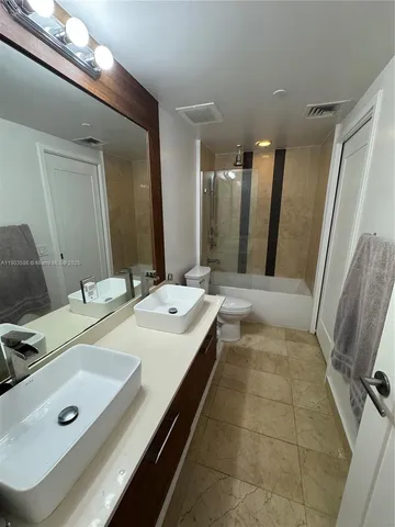 a bathroom with a double vanity sink and mirror
