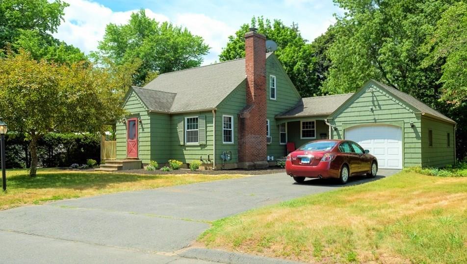 a front view of a house with swimming pool and porch