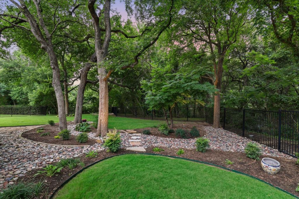 6512 Old Gate Road Plano, TX 75024 - Photo 7 of 40 Backing to a creek provides the perfect backdrop for enjoyable entertaining or lounging in your back yard.