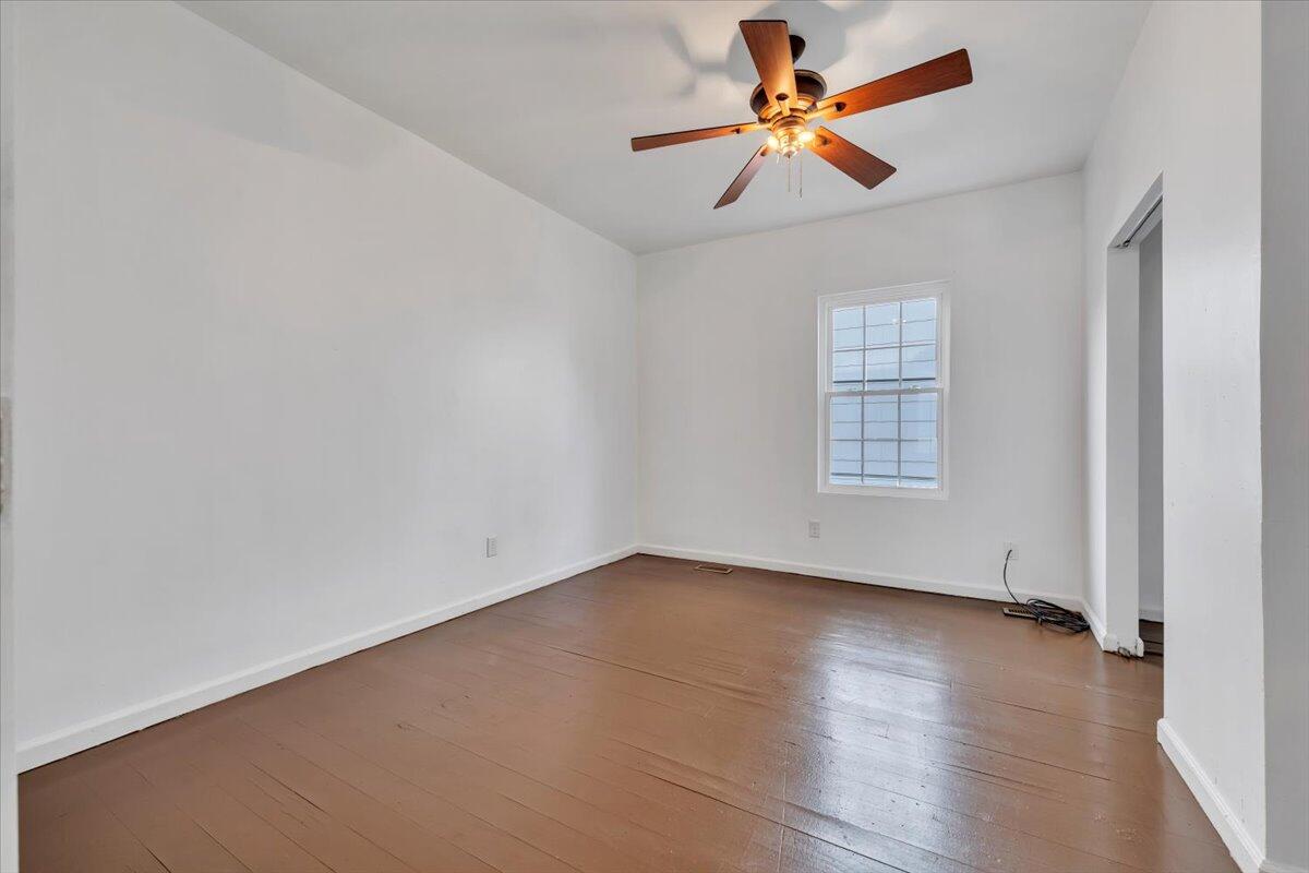 1013 Jamison Avenue Southeast Roanoke, VA 24013 - Photo 11 of 20 an empty room with wooden floor and windows