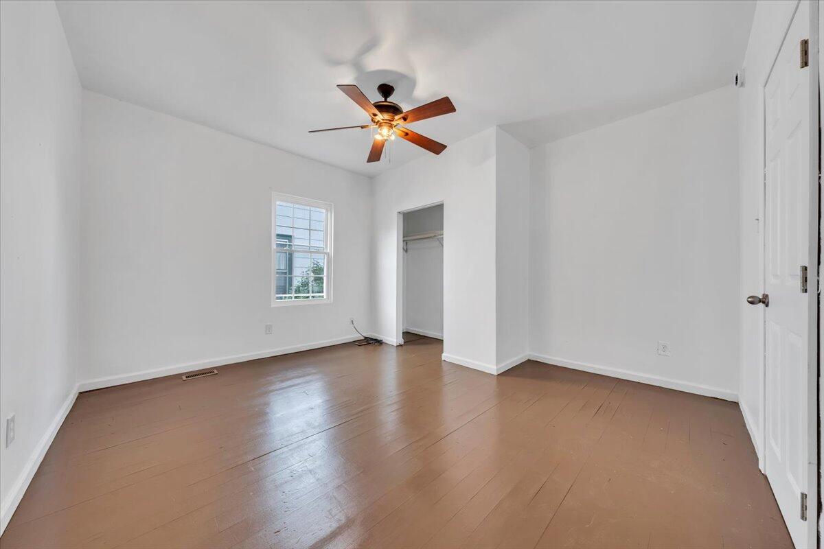 1013 Jamison Avenue Southeast Roanoke, VA 24013 - Photo 12 of 20 an empty room with windows and fan