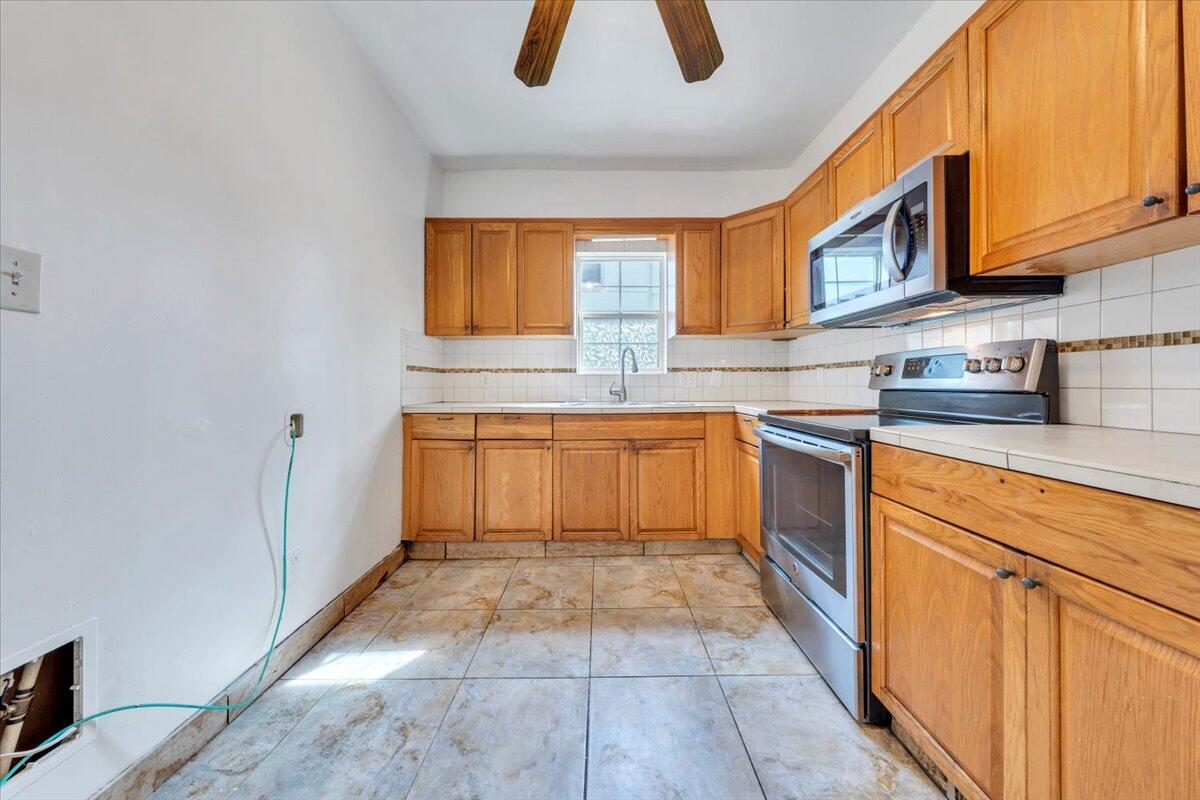 1013 Jamison Avenue Southeast Roanoke, VA 24013 - Photo 14 of 20 a kitchen with granite countertop a sink and cabinets