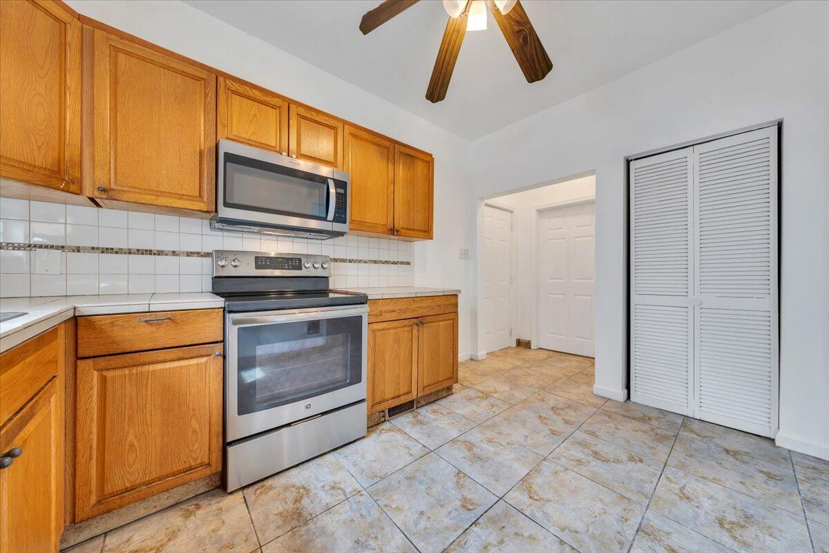 1013 Jamison Avenue Southeast Roanoke, VA 24013 - Photo 16 of 20 a kitchen with stainless steel appliances granite countertop a stove a sink and a microwave