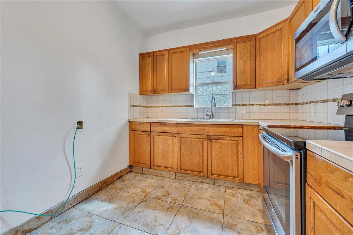 1013 Jamison Avenue Southeast Roanoke, VA 24013 - Photo 17 of 20 a kitchen with stainless steel appliances granite countertop a sink and a cabinets