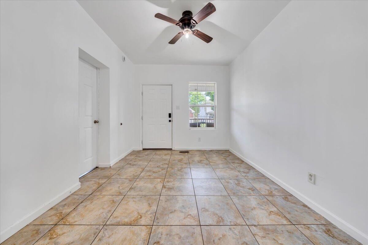 1013 Jamison Avenue Southeast Roanoke, VA 24013 - Photo 3 of 20 a view of a livingroom with a chandelier fan and windows