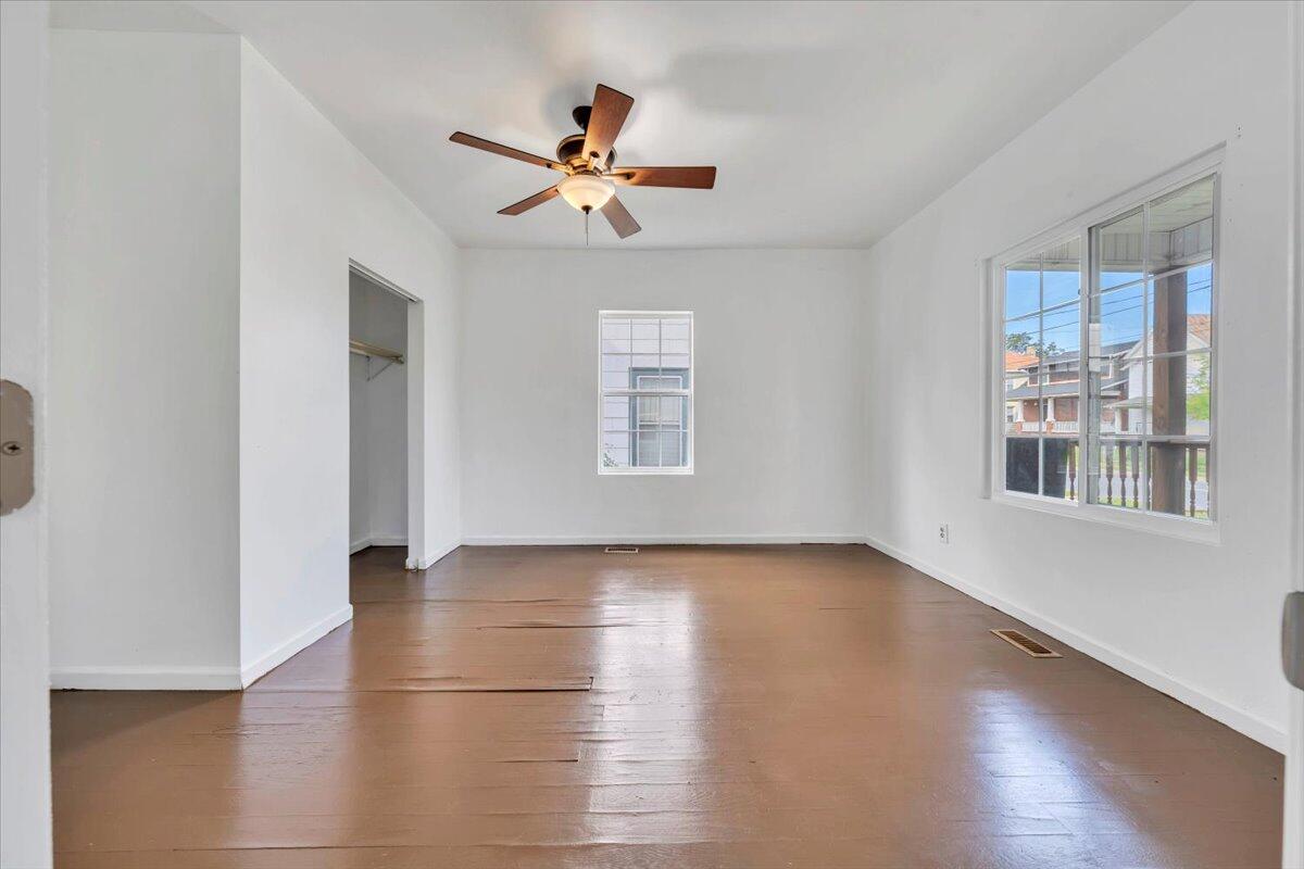 1013 Jamison Avenue Southeast Roanoke, VA 24013 - Photo 5 of 20 a view of empty room with wooden floor and fan
