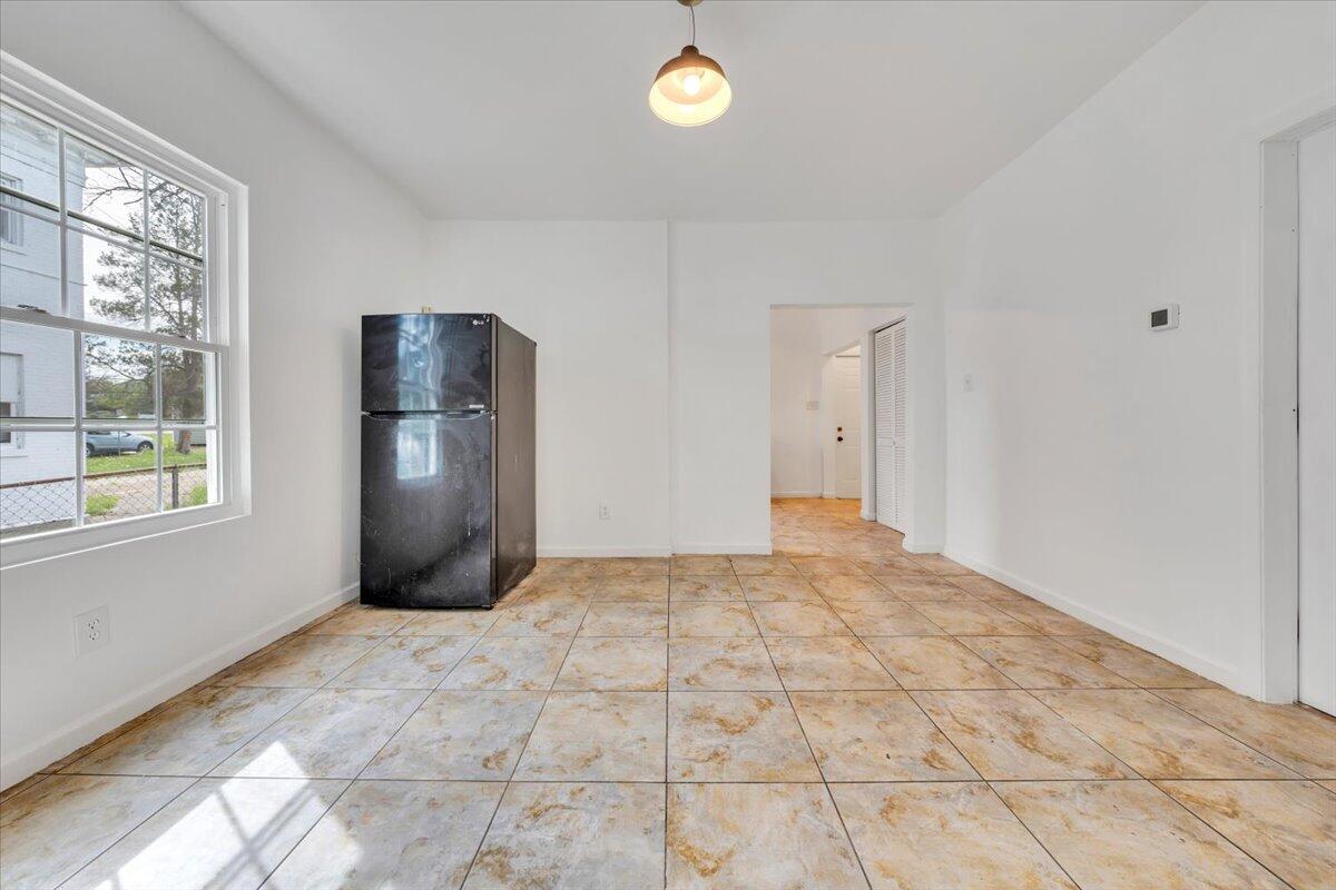 1013 Jamison Avenue Southeast Roanoke, VA 24013 - Photo 8 of 20 a view of empty room with window and wooden floor