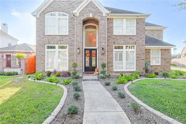 a front view of a house with garden