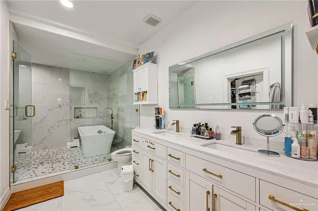 a bathroom with a double vanity sink mirror and shower