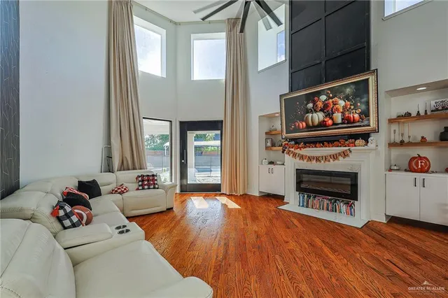 a living room with furniture a flat screen tv and a fireplace