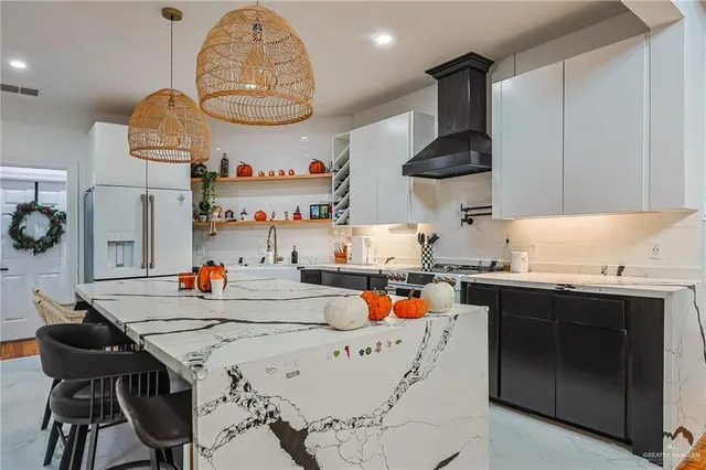 a kitchen with a stove a sink and a dining table