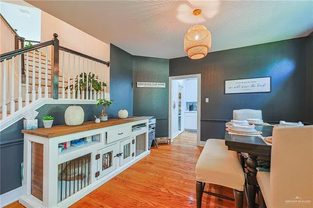 a dining room with furniture a chandelier and a rug
