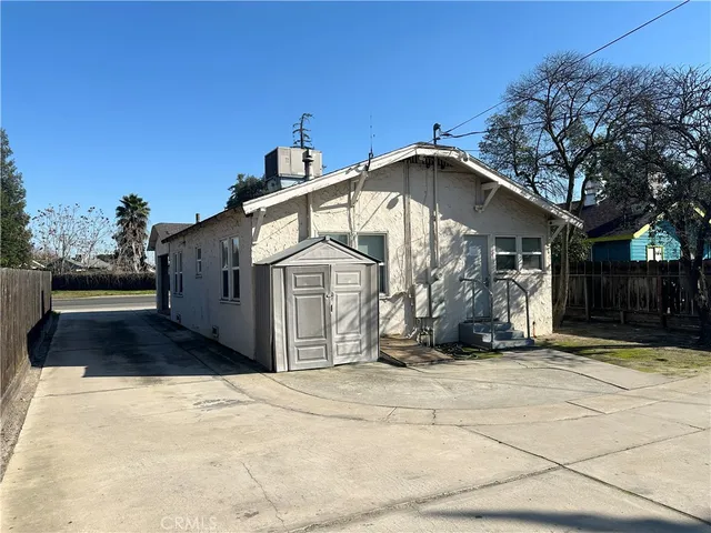 a view of a house with wooden fence