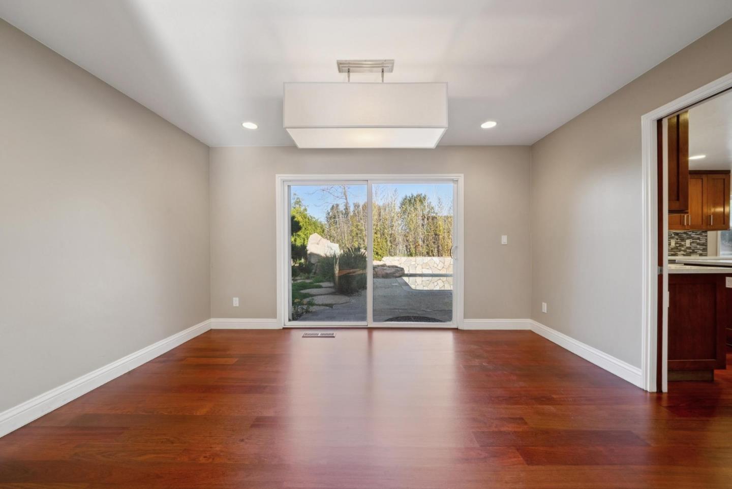 900 Highlands Circle Los Altos, CA 94024 - Photo 11 of 76 a view of an empty room with wooden floor and a window