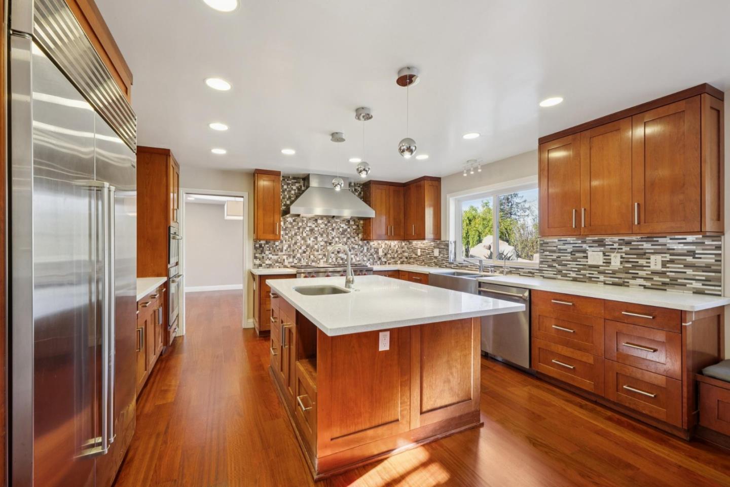 900 Highlands Circle Los Altos, CA 94024 - Photo 16 of 76 a kitchen with stainless steel appliances granite countertop a sink a stove and a refrigerator
