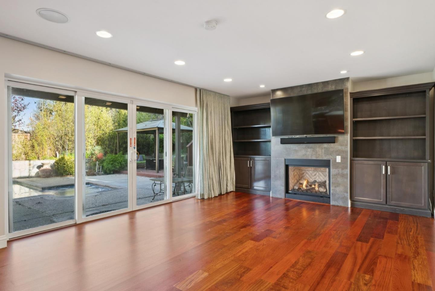 900 Highlands Circle Los Altos, CA 94024 - Photo 21 of 76 a view of an empty room with a fireplace and a window