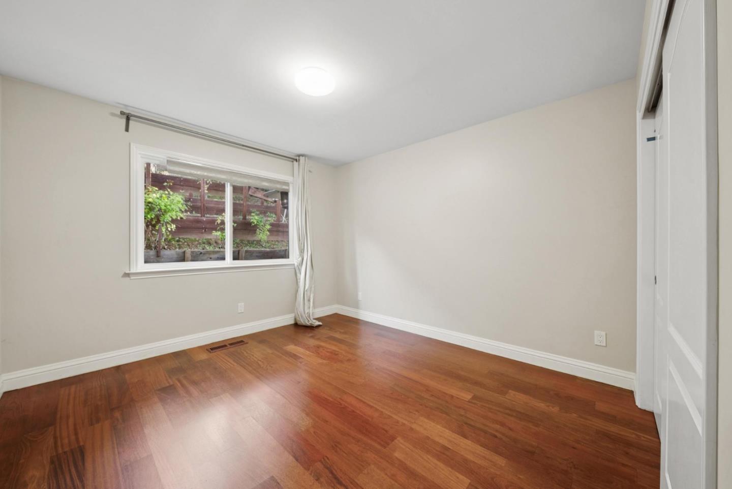 900 Highlands Circle Los Altos, CA 94024 - Photo 27 of 76 an empty room with wooden floor and windows