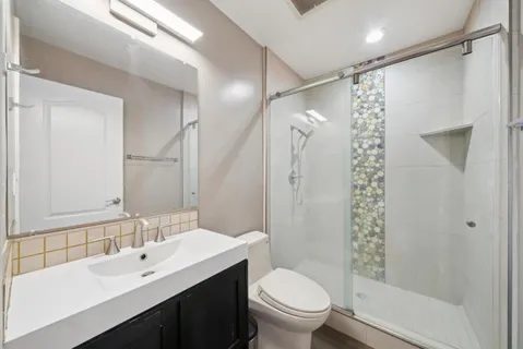 a view of backyard with table and chairs under an umbrella with a small yard