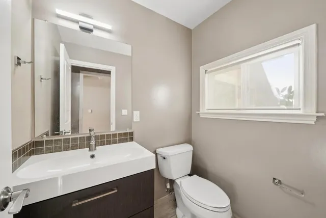 a backyard of a house with potted plants and wooden fence