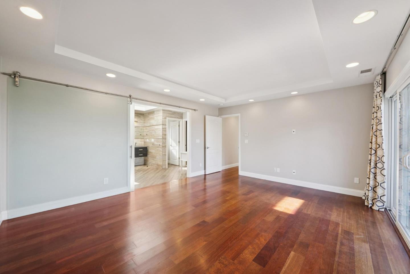900 Highlands Circle Los Altos, CA 94024 - Photo 34 of 76 a view of an empty room with wooden floor and a window