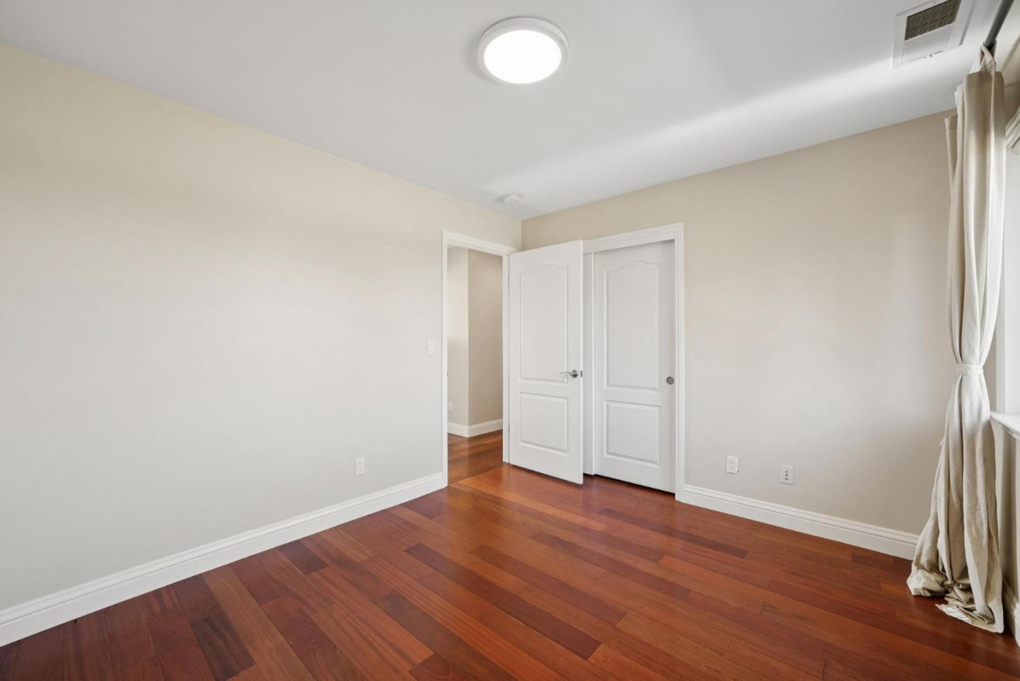 900 Highlands Circle Los Altos, CA 94024 - Photo 47 of 76 a view of an empty room with wooden floor and a window