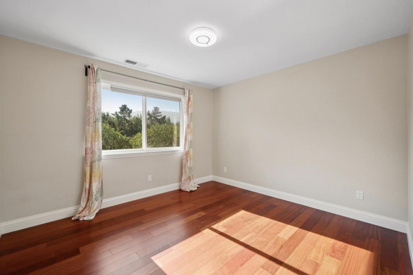 900 Highlands Circle Los Altos, CA 94024 - Photo 50 of 76 an empty room with wooden floor and windows