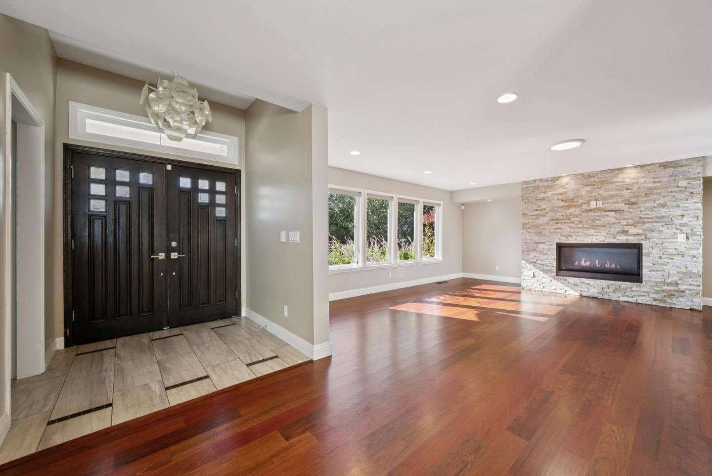 900 Highlands Circle Los Altos, CA 94024 - Photo 5 of 76 an empty room with wooden floor chandelier and windows