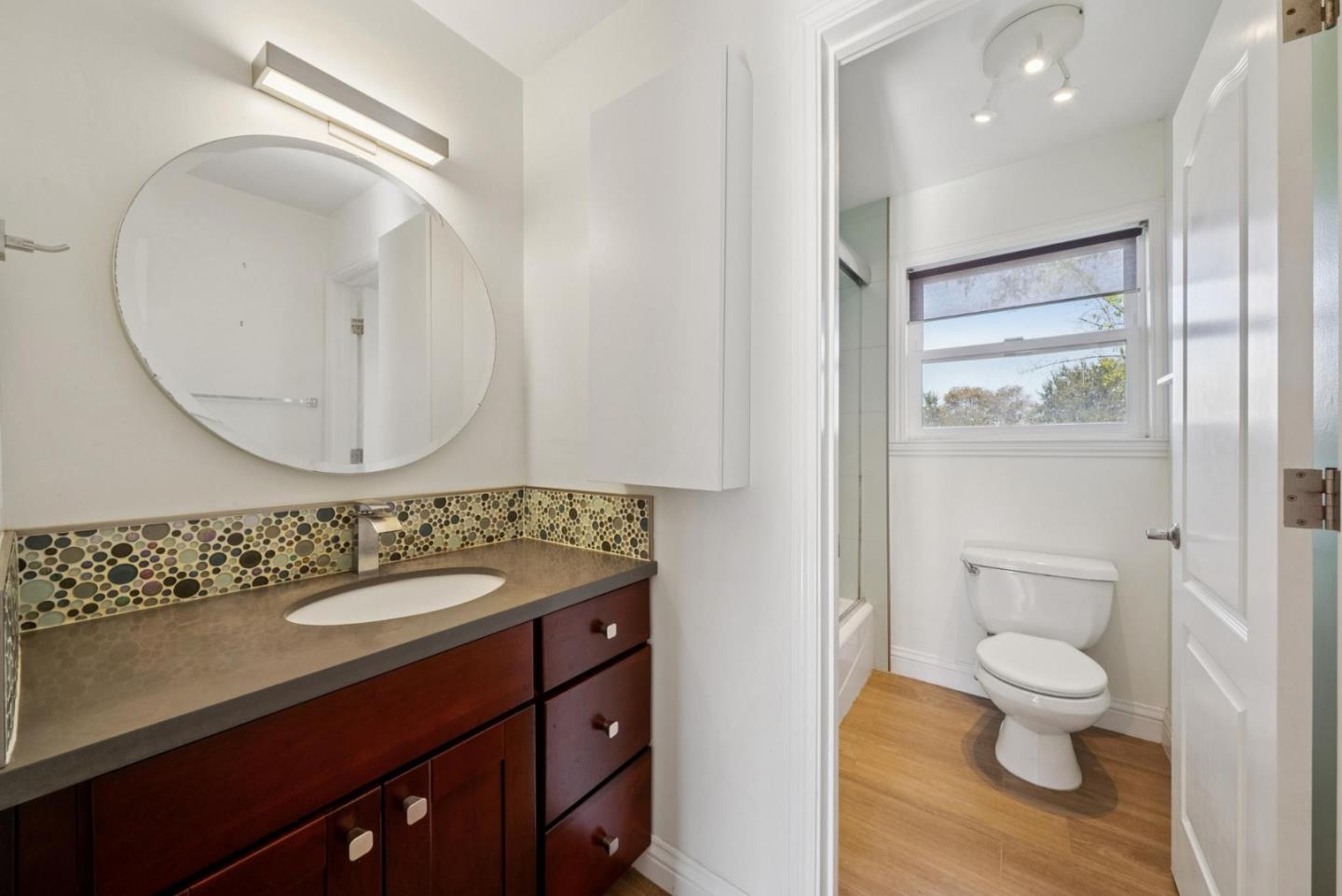 900 Highlands Circle Los Altos, CA 94024 - Photo 53 of 76 a bathroom with a sink a toilet and a mirror