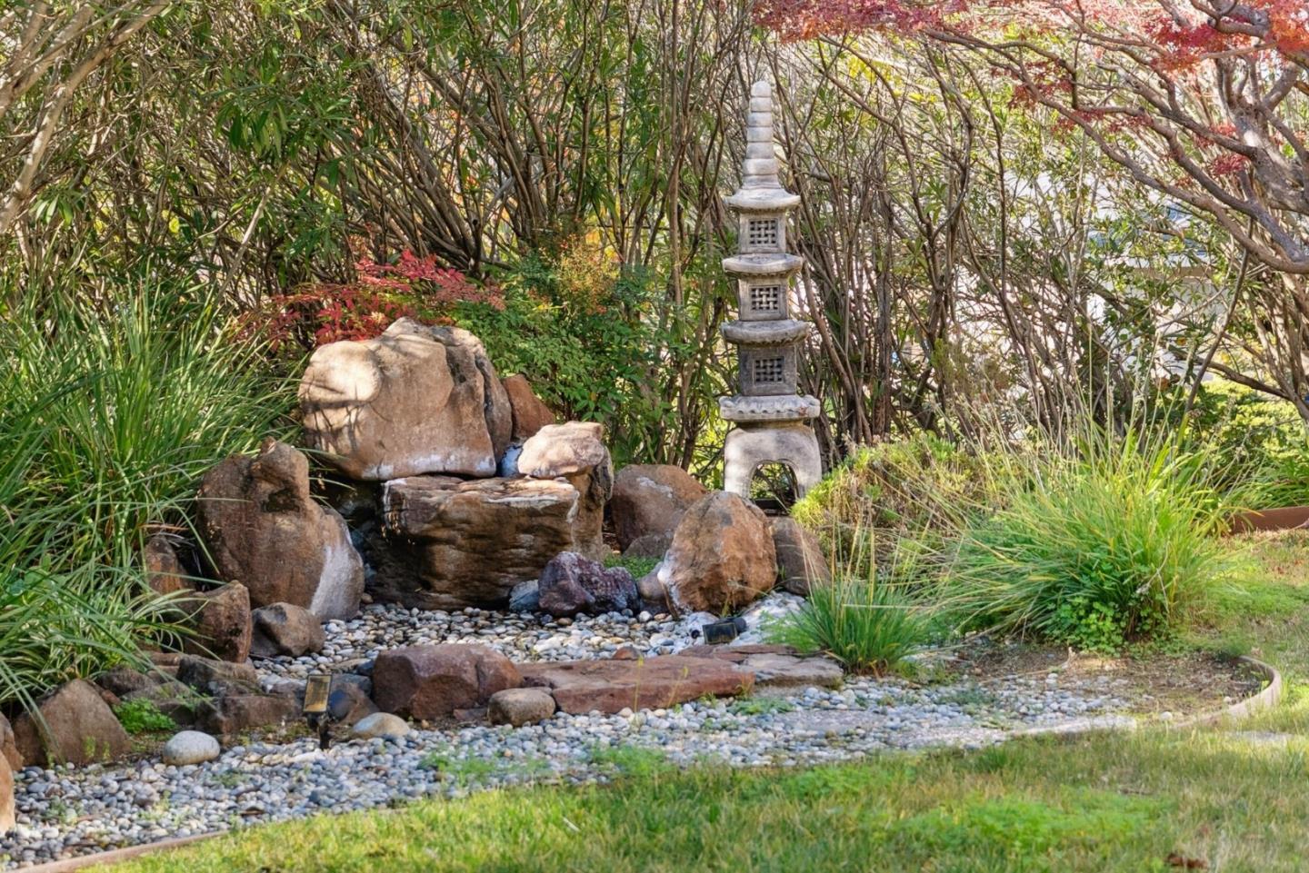 900 Highlands Circle Los Altos, CA 94024 - Photo 62 of 76 a view of a backyard with fountain plants and large tree