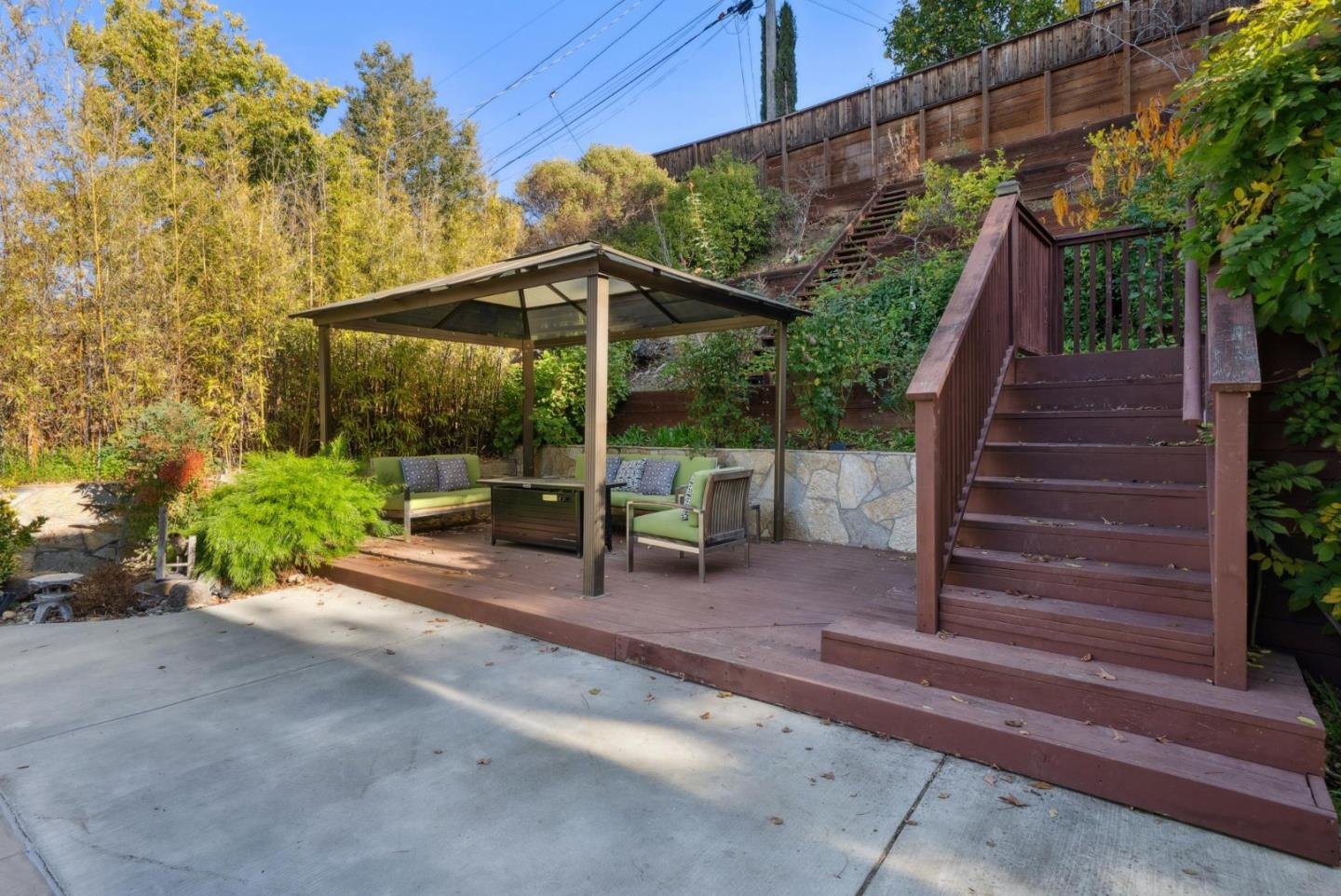 900 Highlands Circle Los Altos, CA 94024 - Photo 64 of 76 a view of backyard with table and chairs under an umbrella with a small yard