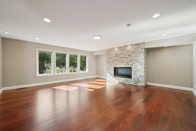 a kitchen with stainless steel appliances granite countertop a sink a stove and a refrigerator