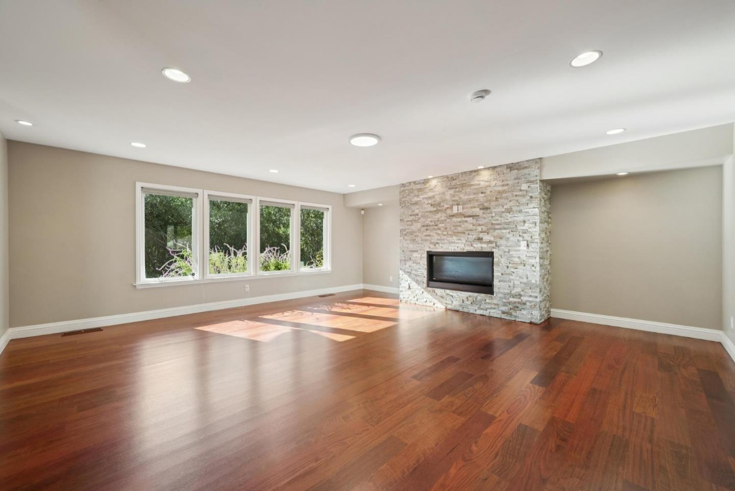 900 Highlands Circle Los Altos, CA 94024 - Photo 7 of 76 an empty room with wooden floor and fireplace