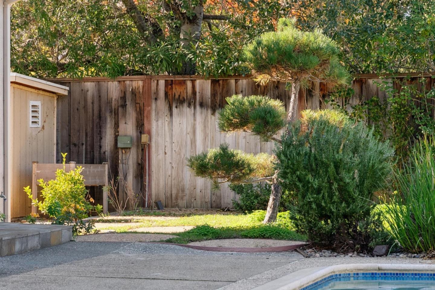 900 Highlands Circle Los Altos, CA 94024 - Photo 71 of 76 a backyard of a house with potted plants and wooden fence