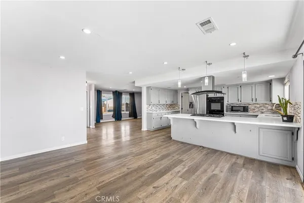 a large white kitchen with lots of counter space a sink and appliances