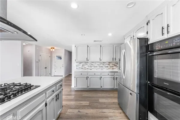 a kitchen with a stove and a refrigerator