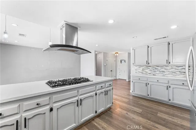 a kitchen with stainless steel appliances a cabinets and a stove top oven