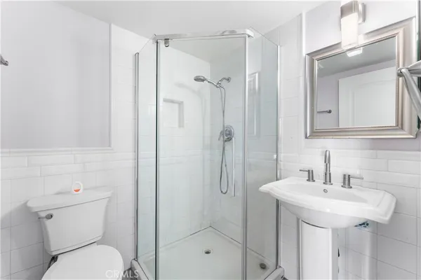 a bathroom with a toilet sink shower and mirror