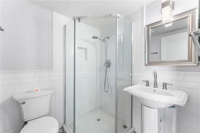 a bathroom with a toilet sink shower and mirror