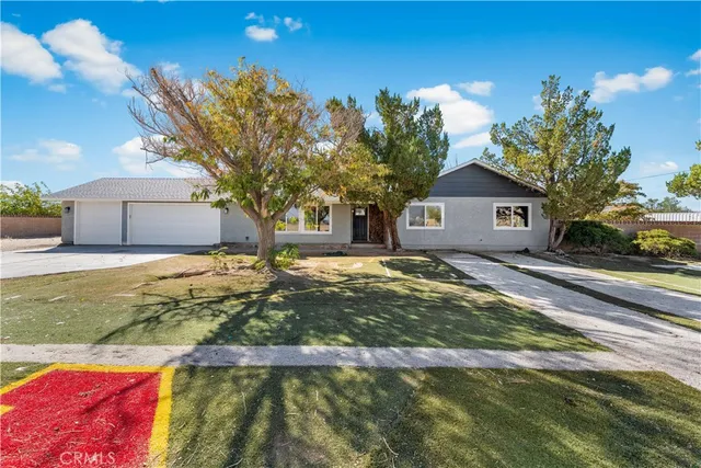 a view of house with backyard