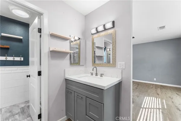 a bathroom with a sink a mirror and a shower