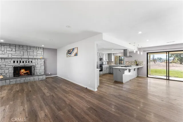 a view of kitchen with a fireplace and wooden floor