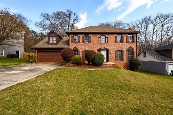 a front view of a house with a garden