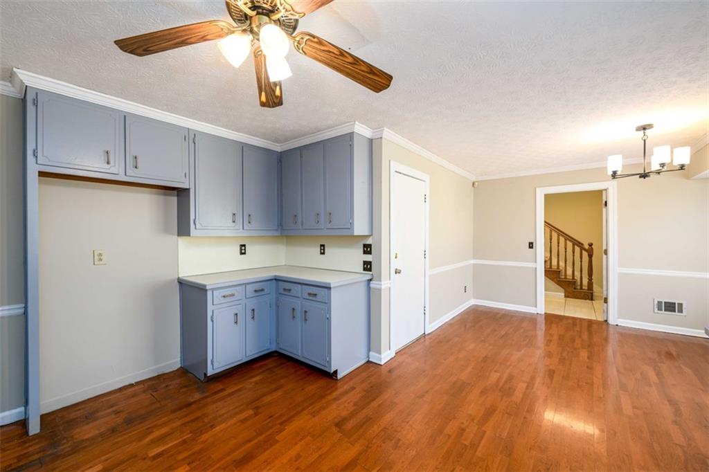 6420 Phillips Place Lithonia, GA 30058 - Photo 13 of 40 a kitchen with a sink cabinets and wooden floor