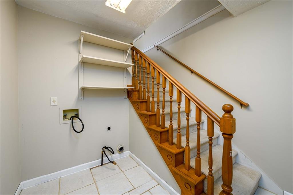 6420 Phillips Place Lithonia, GA 30058 - Photo 17 of 40 a view of staircase with wooden floor and stairs