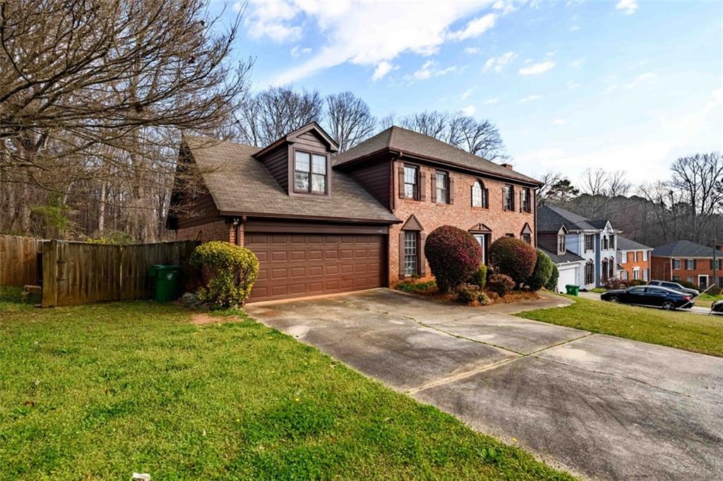 6420 Phillips Place Lithonia, GA 30058 - Photo 2 of 40 a view of a house with backyard and a tree